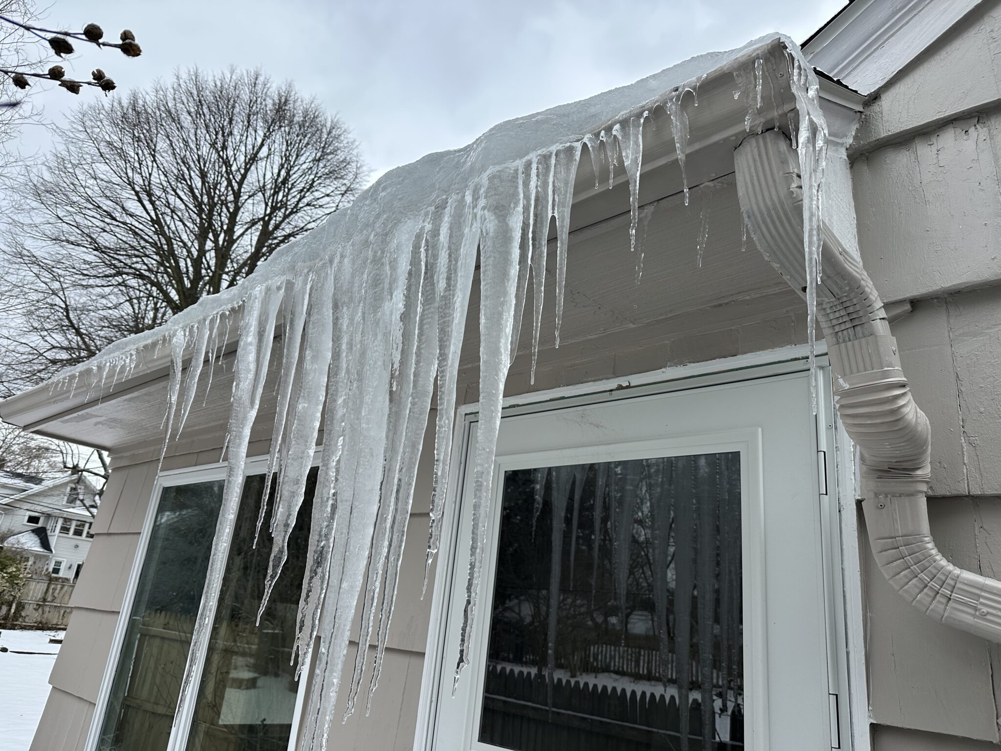 Ice damming in the gutters and roof of a house in Rochester, NY